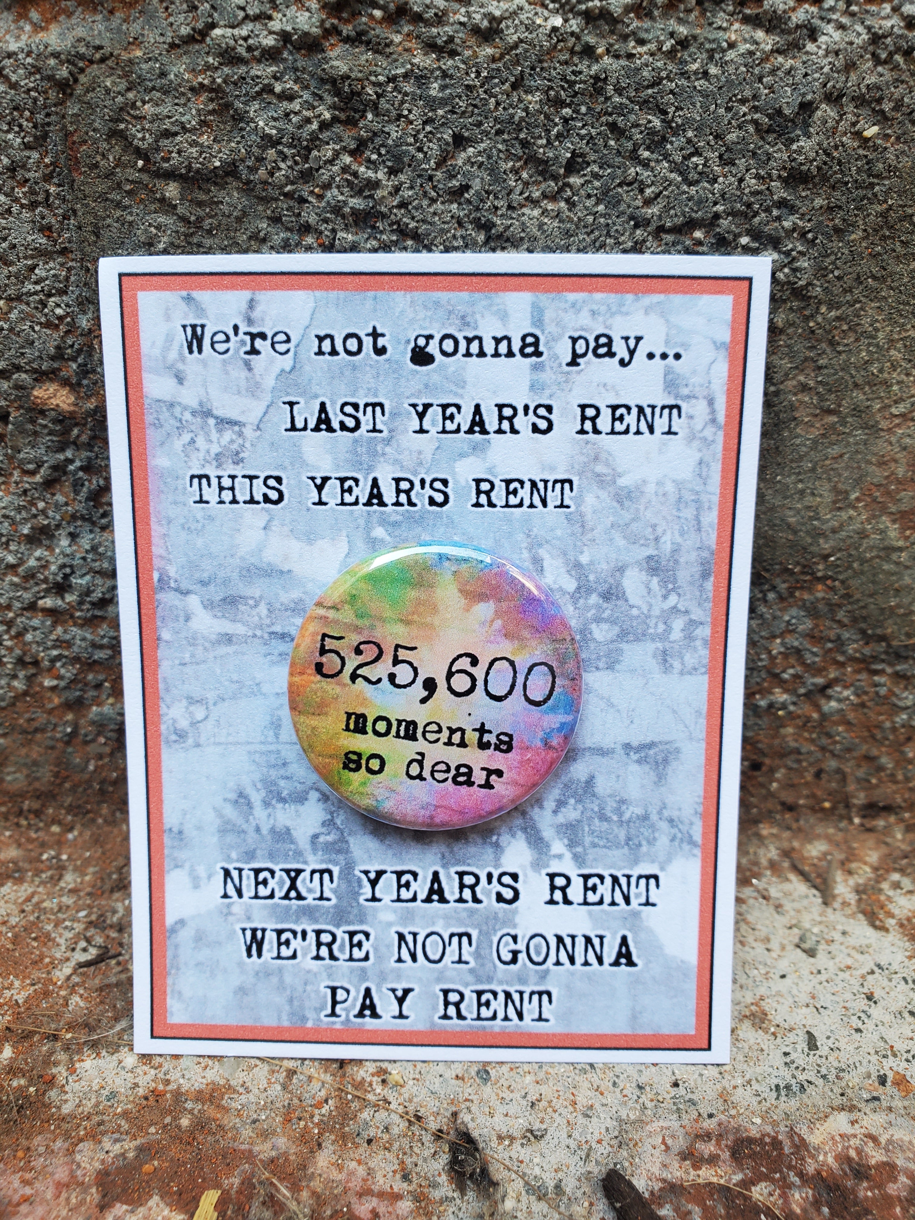 A musical gift featuring the words "we're not gonna pay last year's rent" would be The Lobby Boutique's RENT "525,600 Moments so dear." Metal Pinback Button. A musical gift featuring the words "we're not gonna pay last year's rent" would be The Lobby Boutique's RENT "525,600 Moments so dear." Metal Pinback Button.