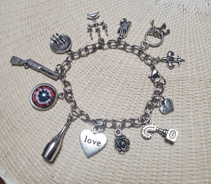 A LES MISERABLES Charm Bracelet from The Lobby Boutique with various charms on it. A LES MISERABLES Charm Bracelet from The Lobby Boutique with various charms on it.