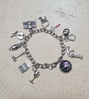 A CHICAGO Charm Bracelet with a variety of themed charms, inspired by Chicago, from The Lobby Boutique. A CHICAGO Charm Bracelet with a variety of themed charms, inspired by Chicago, from The Lobby Boutique.