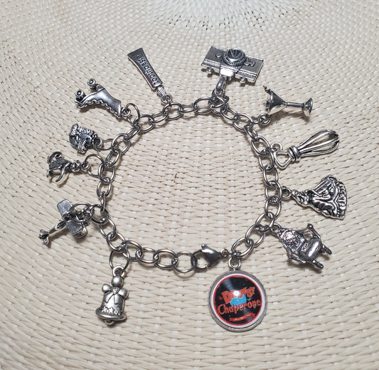 A DROWSY CHAPERONE Charm Bracelet from The Lobby Boutique, with a variety of charms on it.