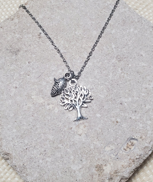 Tree of life necklace made of silver metal, inspired by Rapunzel and the INTO THE WOODS keepsake: INTO THE WOODS Rapunzel Necklace, from The Lobby Boutique, made of silver metal.
