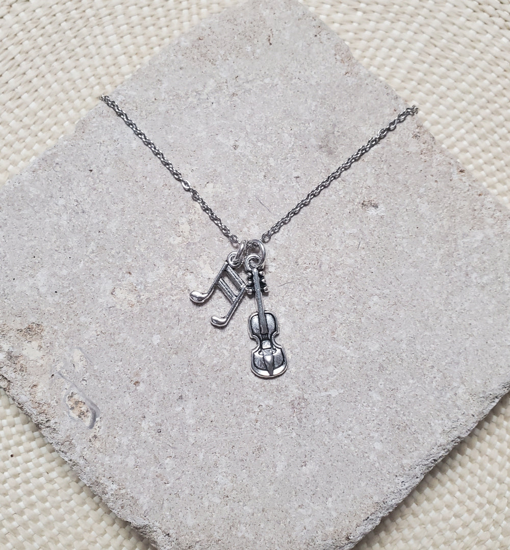 A FIDDLER ON THE ROOF Fiddle Charm Necklace from The Lobby Boutique with a violin charm and musical notes.