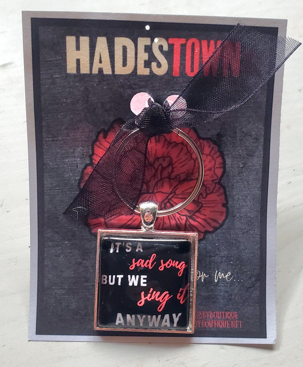 HADESTOWN "It's A Sad Song" Glass Cabachon Keychain (Copy)